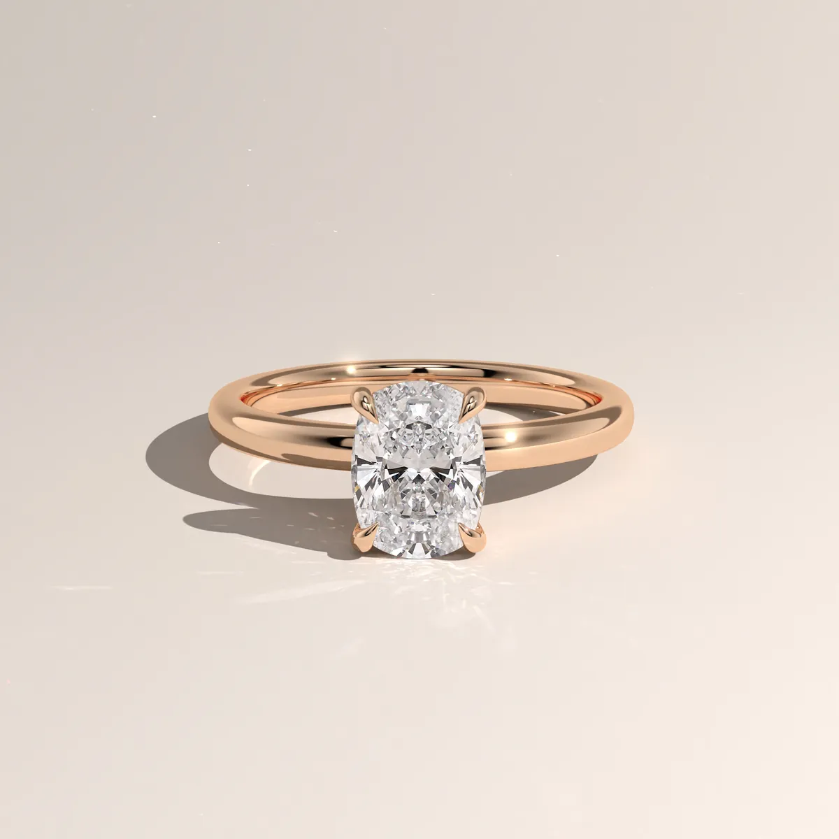 Photorealistic 3D render of a cushion-cut solitaire ring in rose gold, three-quarter view